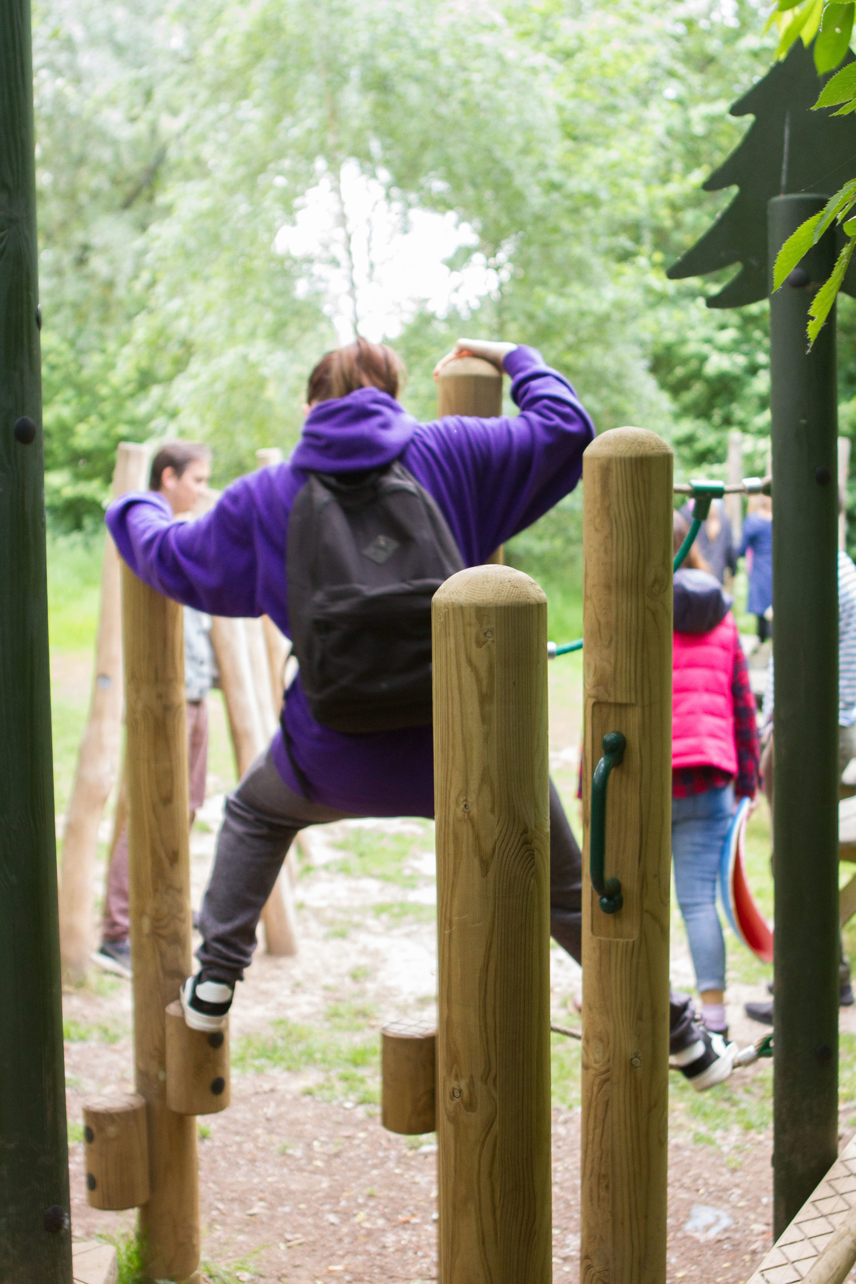 Child climbing on wooden playground