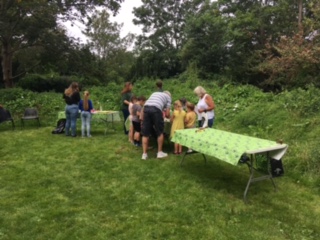 People around a table in woodland