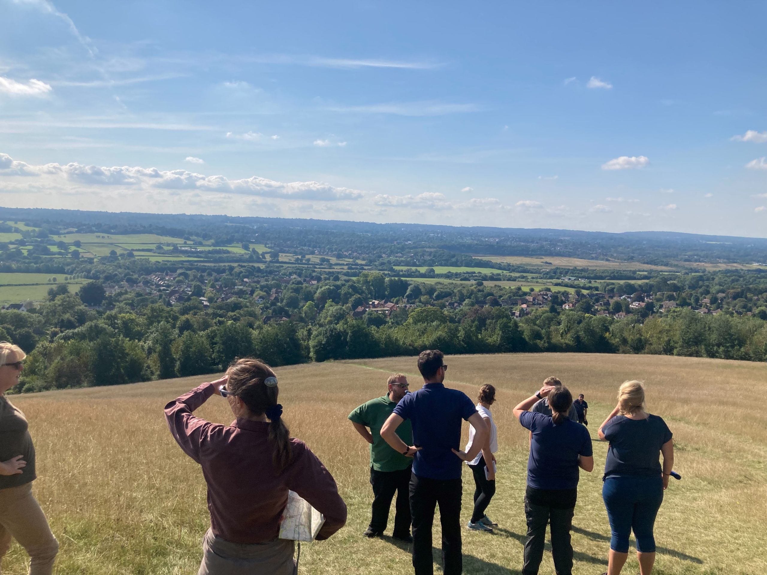 People stood on top of field looking at view
