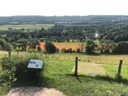 Panoramic view of grass hillside and Shoreham village below